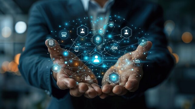 A businessman holds out his hands, conjuring a network of glowing digital icons representing various aspects of connectivity and data management, symbolizing digital transformation in business.