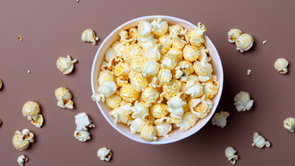 Popcorn In Bowl With Scattered Pieces Around It On Background With Shadows