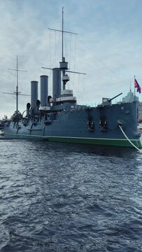 St. PETERSBURG, RUSSIA - April 20, 2024: The Aurora Cruiser Museum on the Neva River on a 20th-century warship. View of the cruiser Aurora, a historical warship, now a war memorial museum. 4К