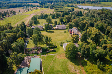 Valmiera, Latvia - August 10, 2023 - Aerial view of Katvaru manor with surrounding greenery and...