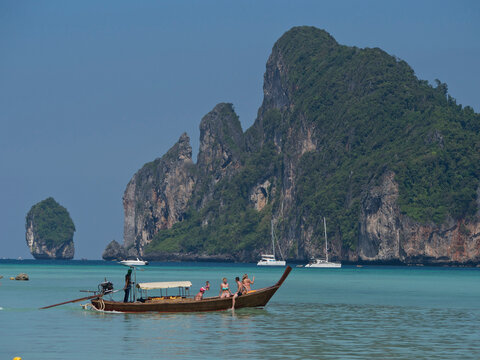 Tourists on long-tail boat in the Phi Phi islands, Andaman sea, Thailand, Southeast Asia, Asia