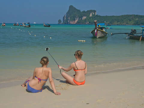 Western women tourists take selfie photo on beach at Phi Phi islands, Andaman sea, Thailand, Southeast Asia, Asia