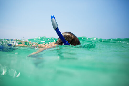 Snorkeler immersed in a turquoise ocean