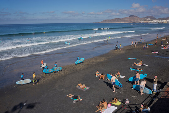 People swimming, surfing, sunbathing and eating on Las Canteras beach in Las Palmas, Gran Canaria, Canary Islands, Spain, Atlantic, Europe