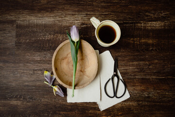 Serene flatlay with tulips and morning coffee on wood.