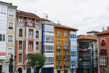 Obraz premium view of the old town colorful houses on cloudy day in portugalete
