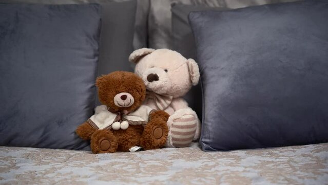 Luxury bedroom with toys on bed. Teddy Bears on the double, grey bed. Close up view.