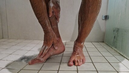 Person Standing on Tiled Floor With Bare Feet