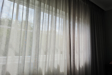 Sheer Curtains and Chair by Window