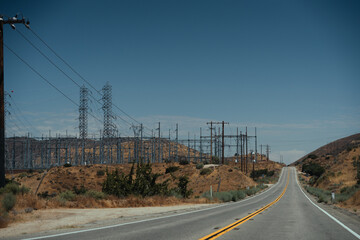 Fototapeta premium On the road in the desert areas of Mojave, California, during summer