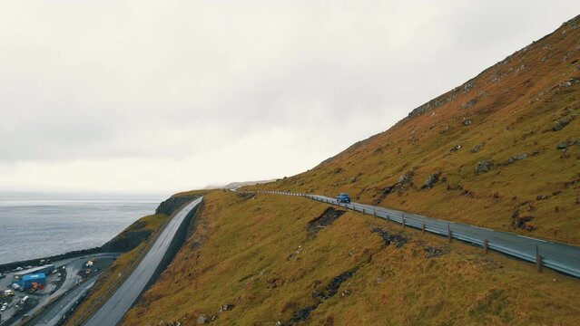 Car Journey Escapade: Cinematic Aerial Views Trailing the Scenic Routes of the Faroe Islands.