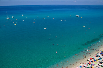 Sea beach with turquoise water and sand where people relax