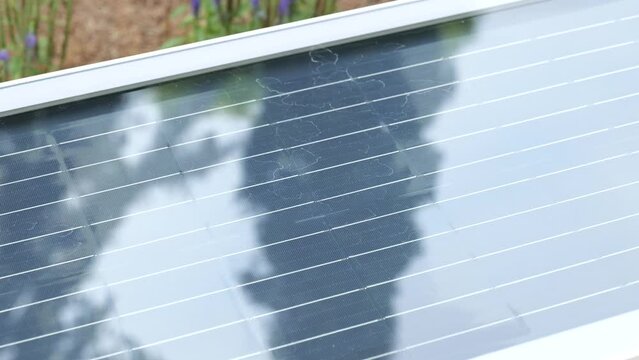 Reflections On Public Solar-Powered Smart Bench For Charging Mobile Devices In Urban Park. Close-up Shot
