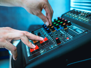 Sound engineer hands adjusting control sound mixer in recording, broadcasting studio,Sound mixer....