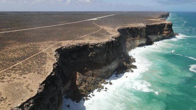 Drone aerial moving backwards over the Great Australian Bight showing crashing waves