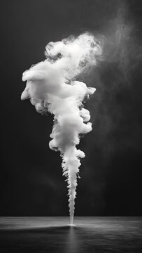 A tall, white smoke plume is rising from the ground. The smoke is thick and billowing, creating a sense of movement and energy. The image evokes a feeling of power and intensity