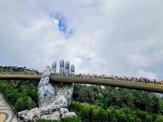 Ba Na Hills - Danang - Vietnam: 13.07.2022 Golden Bridge in cloudy day. This is in Ba Na Hills French Village Mountain Resort, The new tourist attraction place in Da Nang, Vietnam.