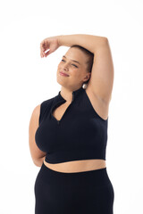 Caucasian young female plus size model poses on white background, copy space