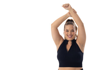 Caucasian plus-size young woman stretches arms up on white background, copy space - 792788868
