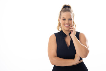 Caucasian young female plus size model on white background wearing black, copy space