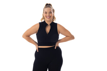 Caucasian young female plus size model on white background, hands on hips, smiling, copy space - 792789448