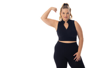 Caucasian plus size young female model flexing arm on white, showing strength - 792789455