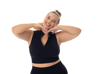 Caucasian young female plus size model poses with hands under chin, smiling, copy space