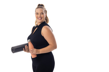 Caucasian young female plus size model with white background holds a yoga mat, copy space - 792789498