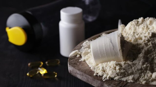 Rotating the dry sports protein powder with a measuring spoon embodies the concept of a healthy and vibrant life.