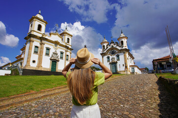 Tourism in Mariana, Minas Gerais, Brazil. Rear view of traveler woman visiting historical town of Mariana with baroque colonial architecture in Minas Gerais, Brazil.