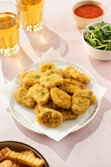 Fast food chicken nuggets paired with a glass of apple juice