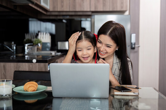Working mom work from home office. businesswoman and cute child using laptop work freelancer workplace in home, Lifestyle family moment