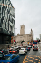 Blurred view of road traffic in Liverpool on a rainy day through the raindrop window of a double decker bus