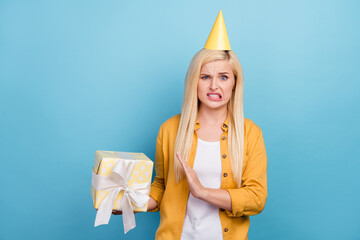 Photo of young blond sad lady no present wear yellow shirt cap isolated on blue color background