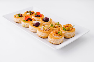 Gourmet assorted mini tartlets on white plate