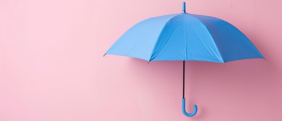 A blue umbrella on a pastel pink background is a minimal concept.