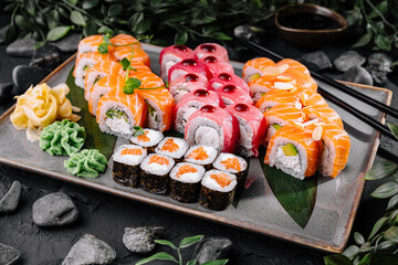 Assorted sushi platter on dark stone background