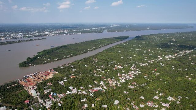 Areal drone shot of Mekong river delta in Vietnam, Ben Tre over the coconut plantations.