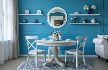 A light blue wall in the dining room, with an elegant round table and two chairs. The walls have decorative elements such as shelves for glassware or vases holding flowers like pink tulips