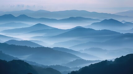 Layers of mist veiling distant mountains, lending an air of mystique to the tranquil valley below.
