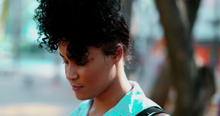 Portrait of a Pensive young black woman standing outdoor in peaceful meditative state, close-up...