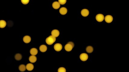 Abstract loop blurred festive yellow gold lights bokeh particles motion 3D animation on black background . Holiday concept backdrop. De-focused light golden particles ember over black background.