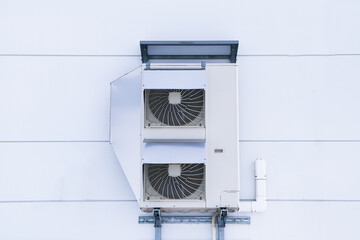 Structure big air conditioner compressor source heat pumps on wall outdoor have cover on side....