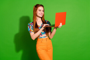 Photo portrait of attractive young woman hold netbook dressed stylish retro clothes isolated on green color background