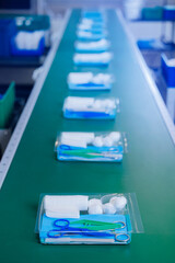 Factory production for equipment of med clinic. Medical instruments Kit surgery on conveyor line, top view