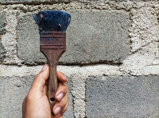 painting the wall, old paint brush