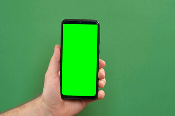 Young man hand use smartphone with green screen on green background. Gestures pack. Male hand...