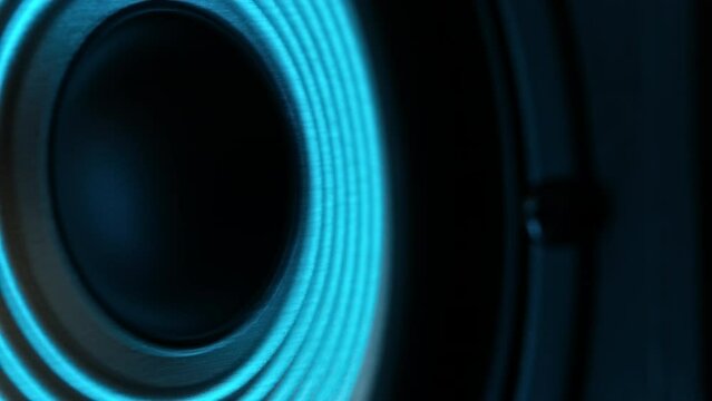 Close-Up Shot Of A Music Speaker Vibrating To The Beat In Blue Light