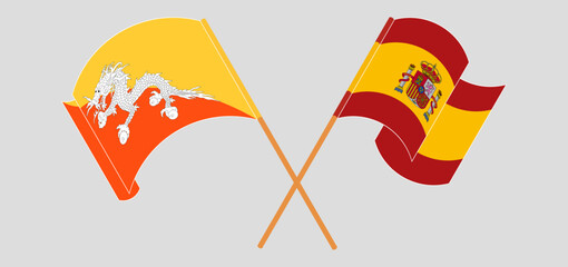 Crossed and waving flags of Bhutan and Spain