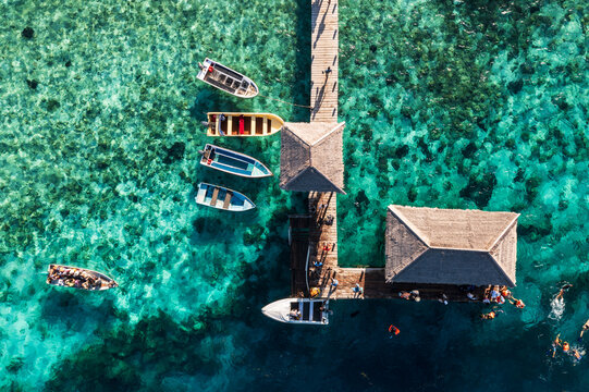 Komodo, Indonesia: Top down view of tourists snorkelling by the jetty of  the Kanawa island  in Komodo near Labuan Bajo in Flores, Indonesia.
